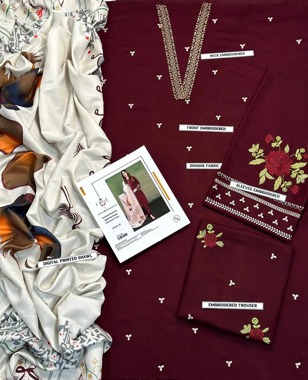 Maroon fabric with embroidery and a card showing a model wearing similar fabric.